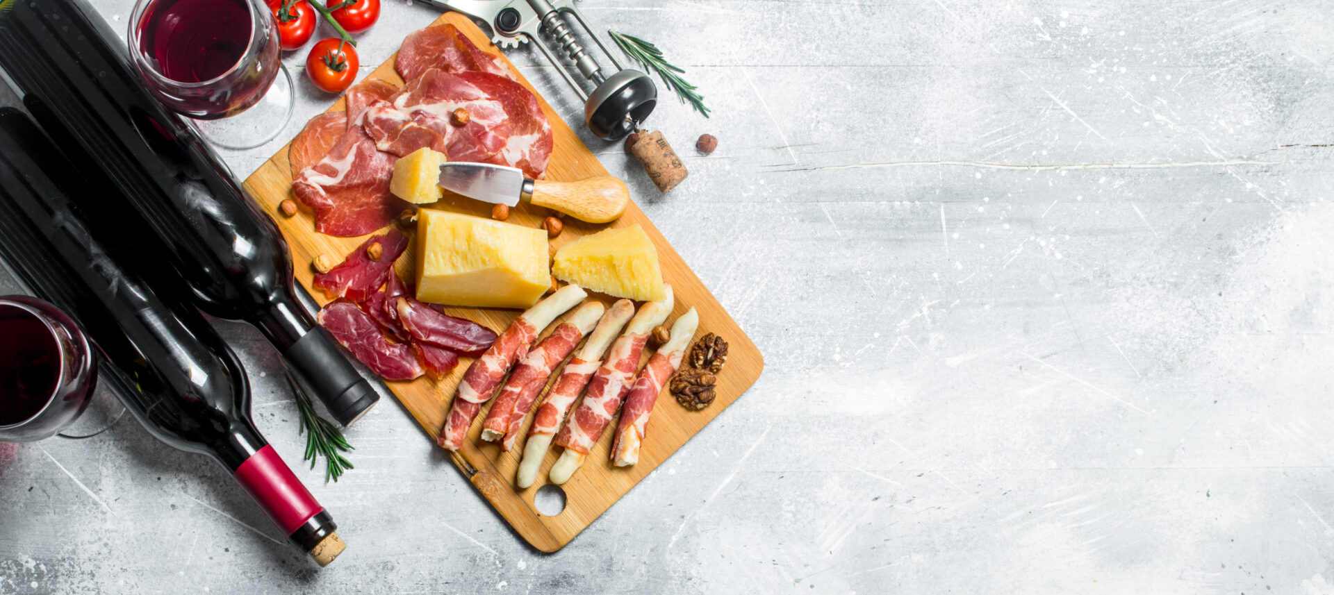 Antipasto background. Various meat and cheese snacks with red wine.